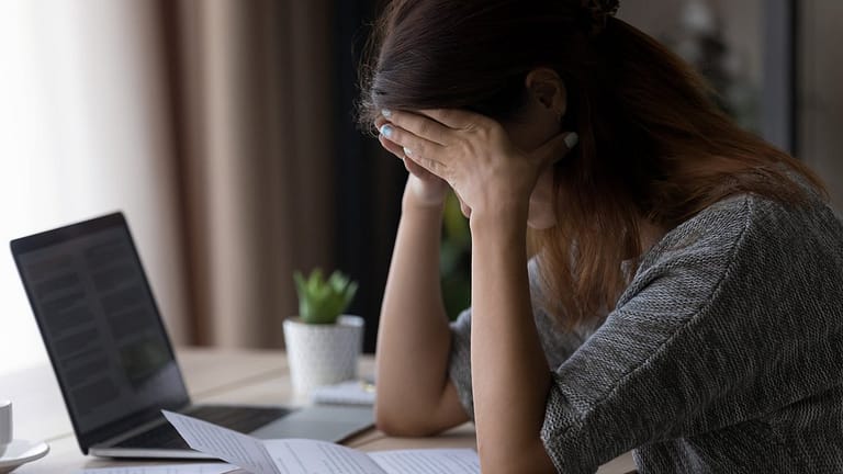Woman appearing upset with head in her hands .width qqzych.jpg