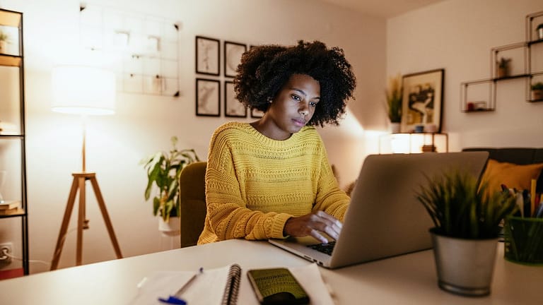 Woman using laptop at home for work or study .width .jpg