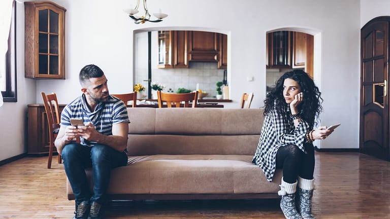 man and woman sitting at opposite ends of a c.width okzr.jpg
