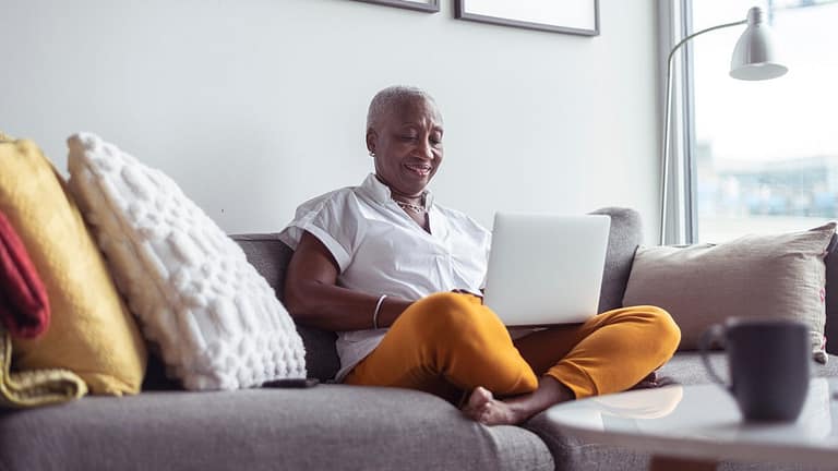 older adult on couch with laptop nNXo.width .jpg