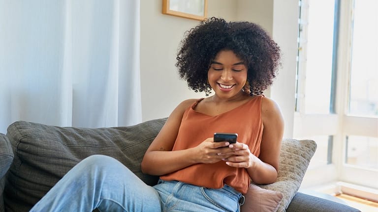 person on couch with phone TIHLN.width .jpg