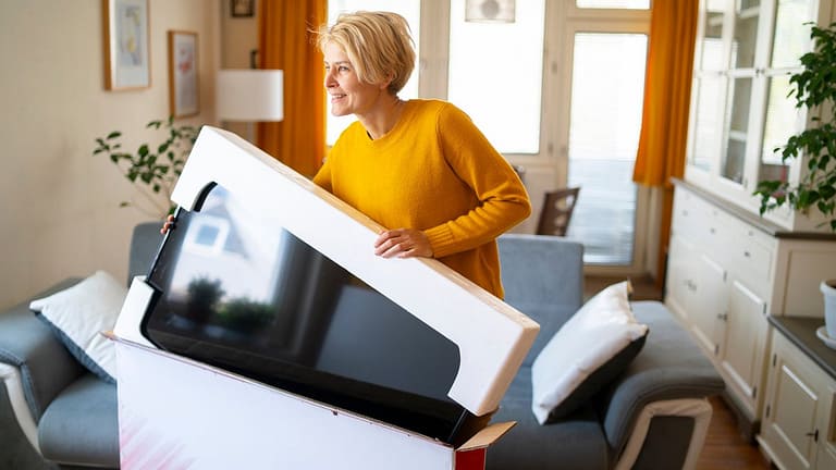 person unboxing new tv iIIanrE.width .jpg