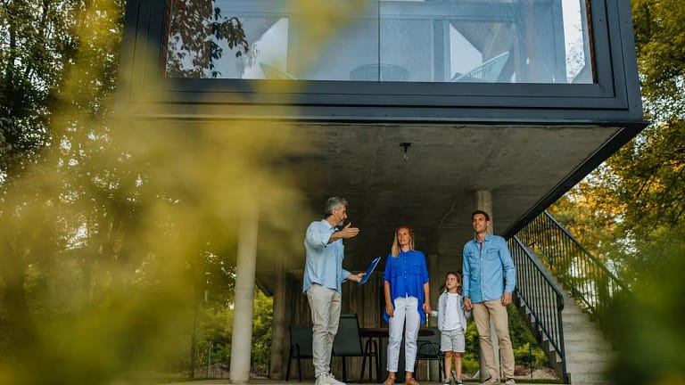 Family talking to realtor by extra modern hom.width jTPPh.jpg