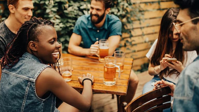 friends drinking beers at patio table WwKdweZ.width .jpg