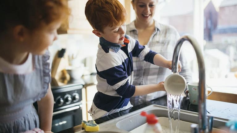 mom and two kids washing dishes.width .jpg