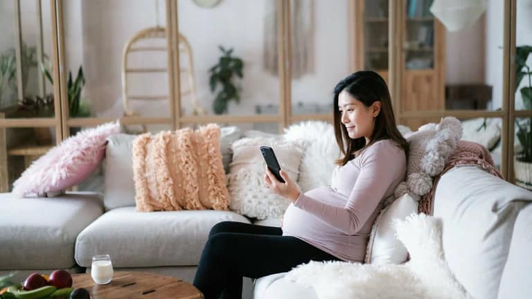 pregnant person on couch with phone GMwLu.width .jpg