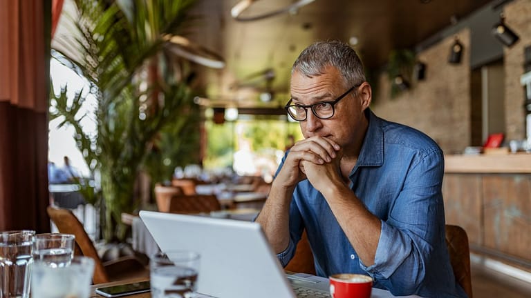 stressed man in cafe QYWidk.width .jpg