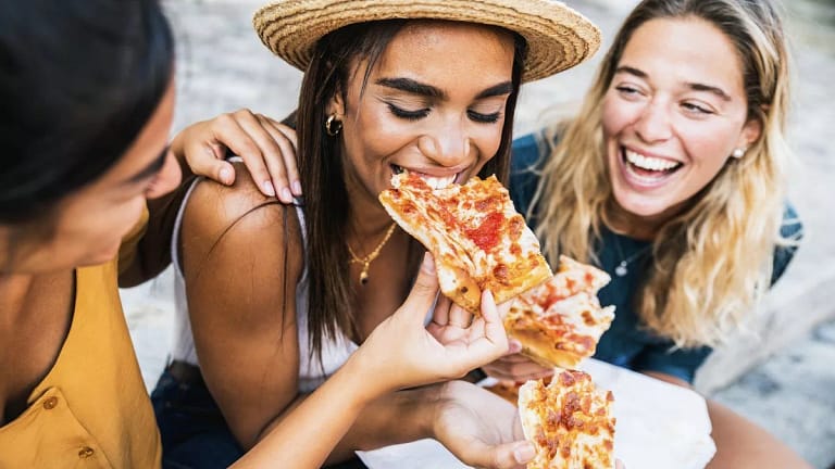 Group of friends enjoying pizza together. Ps.width .jpg
