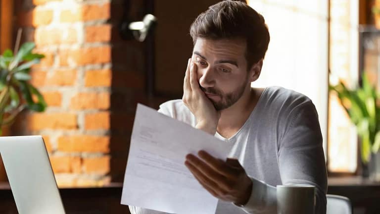 StressedOutGuyLookingAtPaper.width .jpg