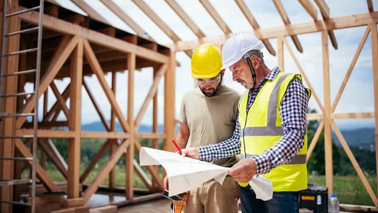 Two builders review blueprints inside an in p.width WEbpsh.jpg