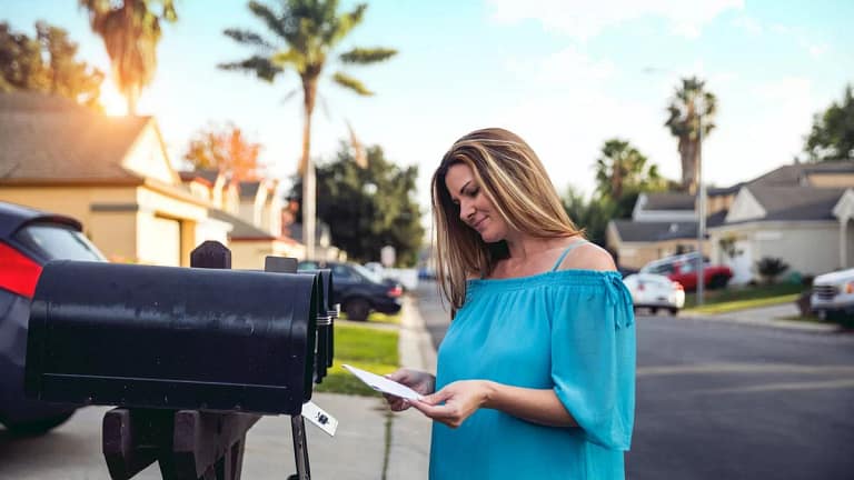 Woman checking mailbox in neighborhood with p.width WPxG.jpg