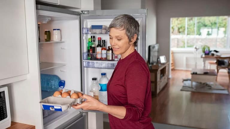 Woman opening refrigerator ymOwHf.width .jpg