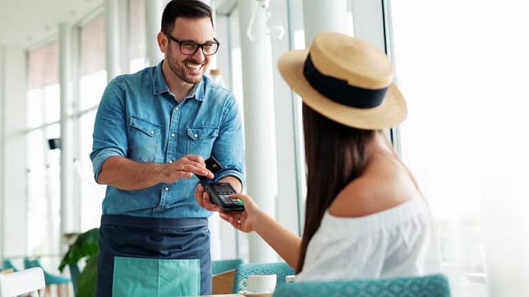Woman paying waiter credit card KqTSHc.width .jpg