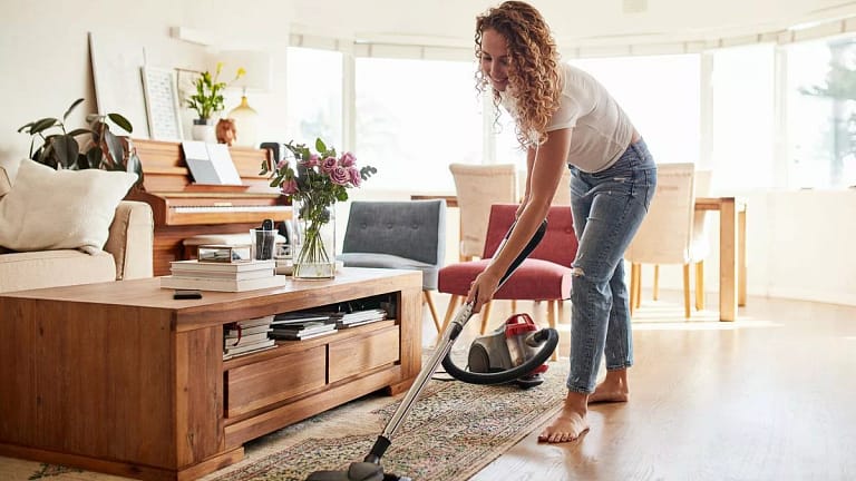 Woman vacuuming her living room QCsTI.width .jpg