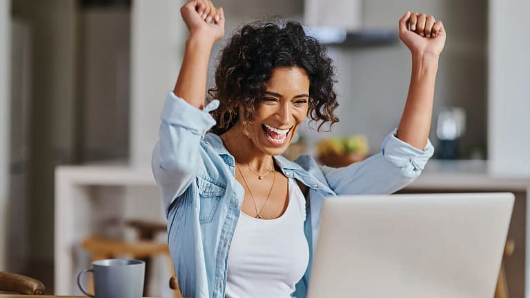 excited woman smilling and looking at computer.jpg