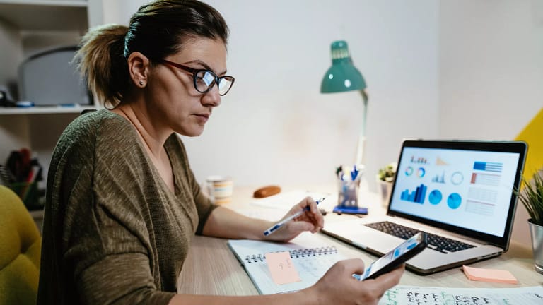 female investor reviewing her portfolio on a laptop.jpg