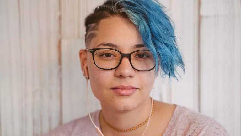 getty blue hair slight smile serious millennial.jpg