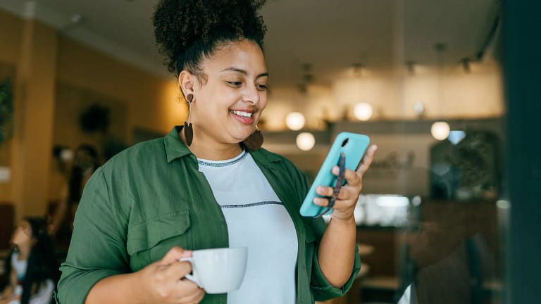 getty happy looking at phone smiling success winning.jpg
