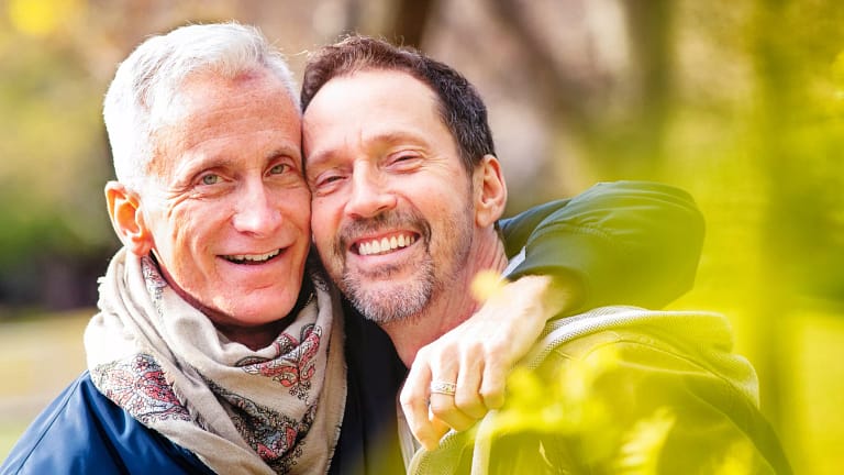 getty happy smiling couple lgbt gay outdoors.jpg