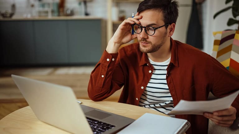 man s laptop holding head gettyimages .jpg