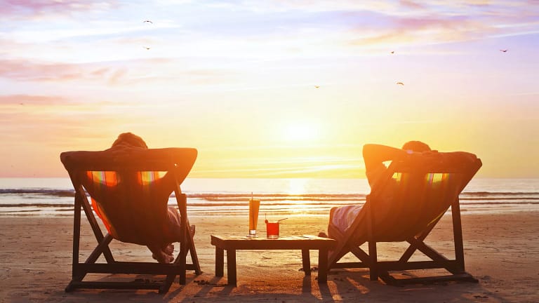 mature couple relaxing on beach at sunset.jpg
