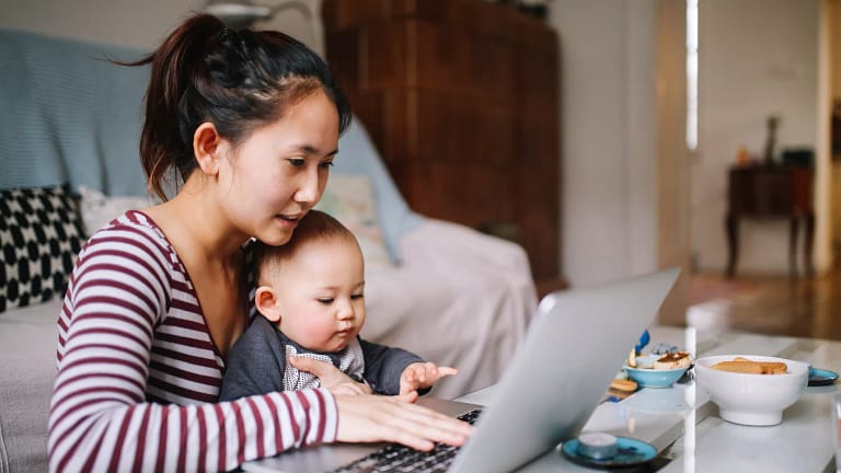 mom laptop holding baby gettyimages .jpg