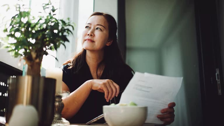 person holding document looking off.jpg