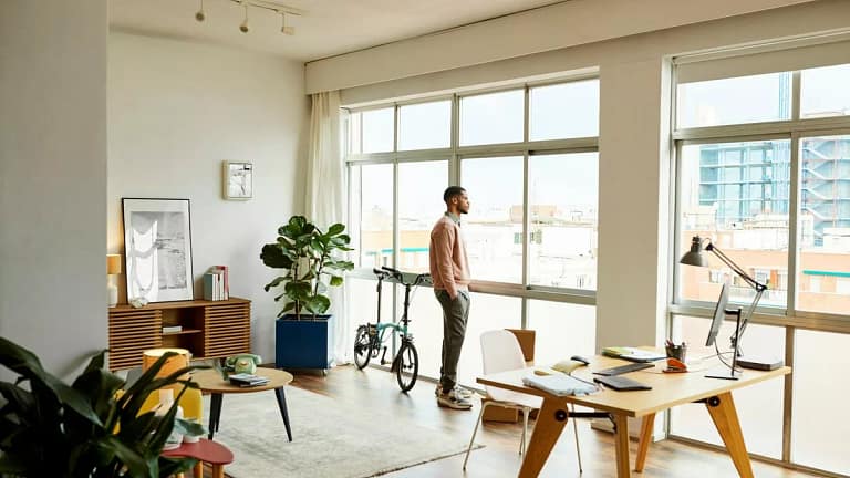 person looking out apartment window PwKvtj.width .jpg