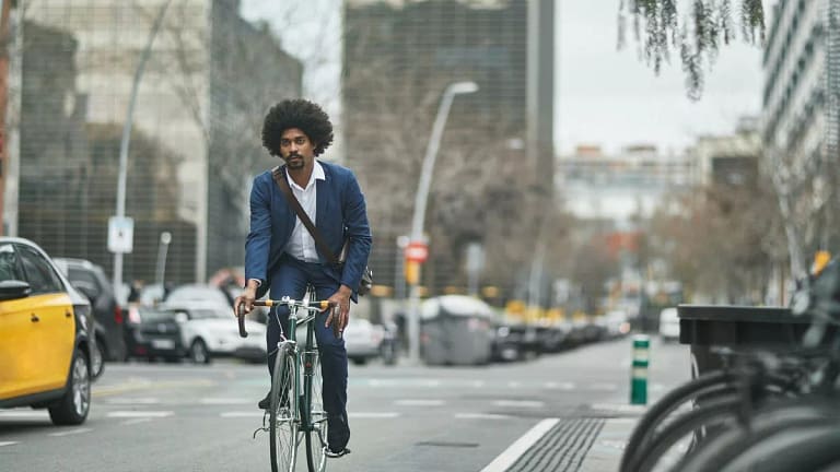 person riding bike on city street kTdlO.width .jpg