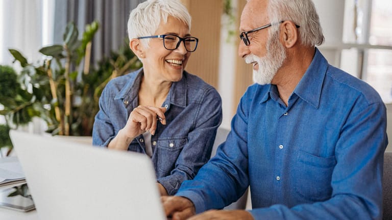 senior couple at laptop smiling gettyimages .jpg