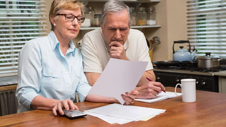 senior couple looking at document gettyimages .jpg