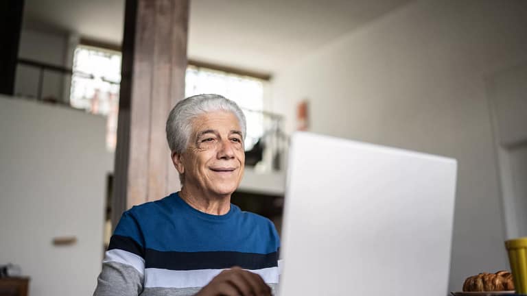 senior laptop smiling gettyimages .jpg