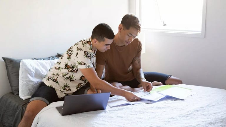 two people sitting on bed with paperwork and .width AejXpPB.jpg