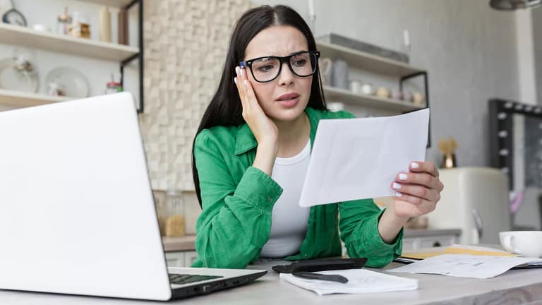 woman s at desk holding doc gettyimages .jpg