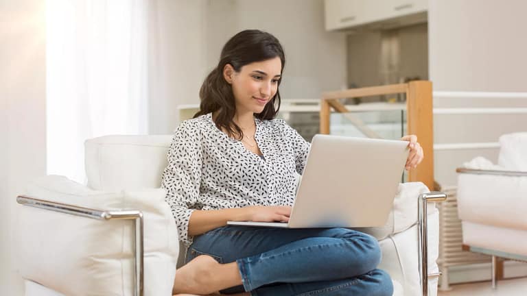 woman s laptop couch gettyimages .jpg