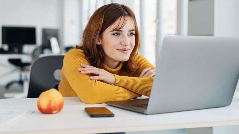 woman s yellow shirt laptop smiling gettyimages .jpg