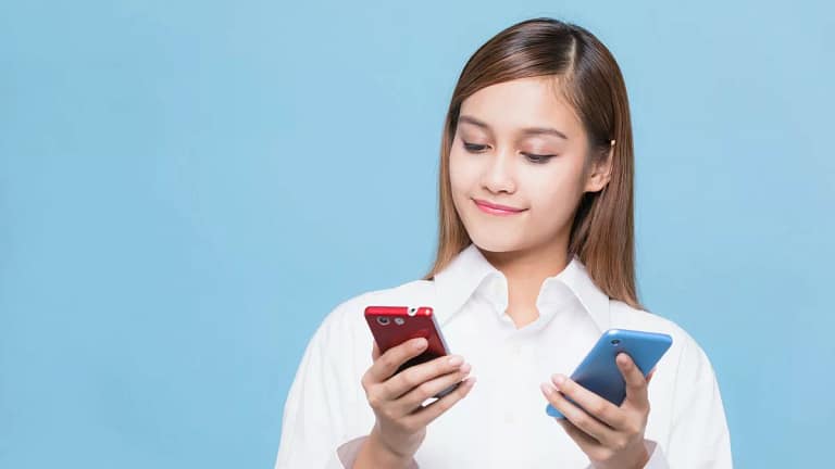 woman looking at red phone and blue phone AyA.width .jpg