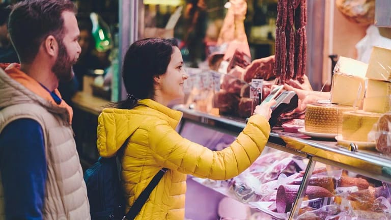 Couple using credit card at farmers market Rc.width .jpg