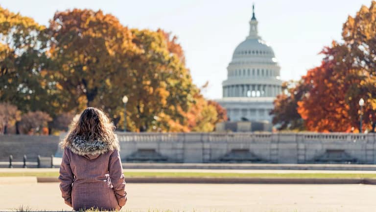 Woman sitting outside the capitol building on.width jUkdkxR.jpg