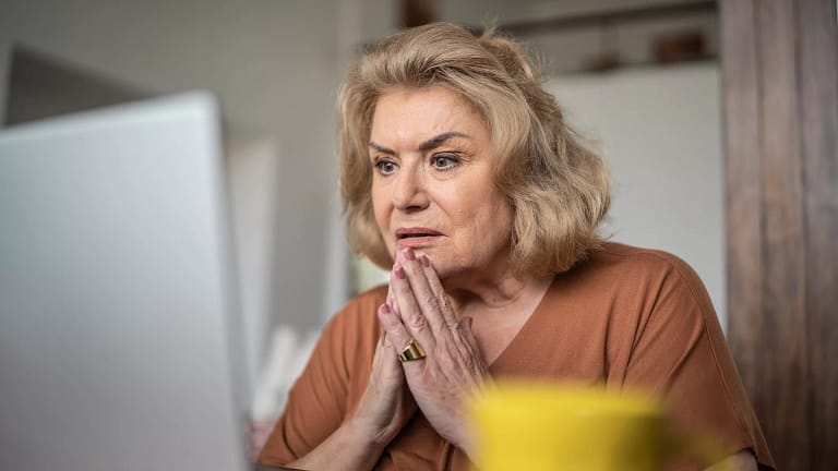 getty person looking at laptop very concerned worried unhappy.jpg