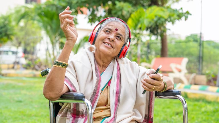 hindu or jain lady in wheelchair with headphones.jpg