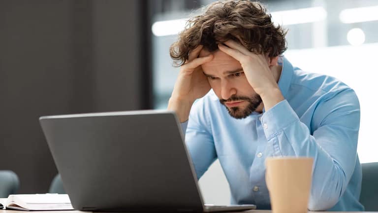 man s laptop upset holding head gettyimages .jpg