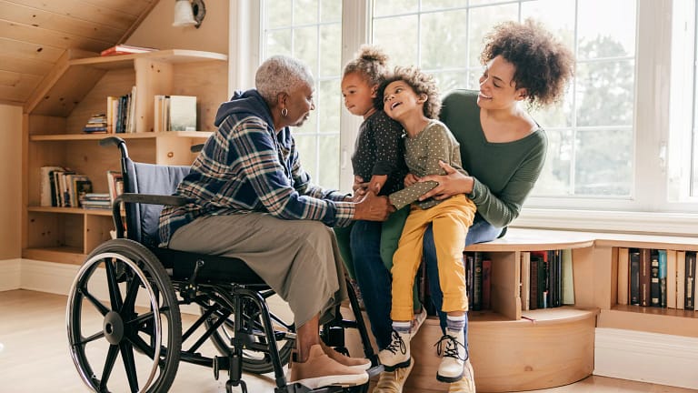 older lady in wheelchair with her famly.jpg