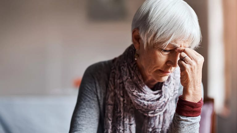 older woman pinching top of nose gettyimages .jpg
