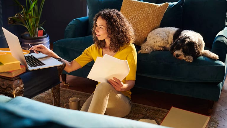 person sitting on the floor looking at a laptop.jpg