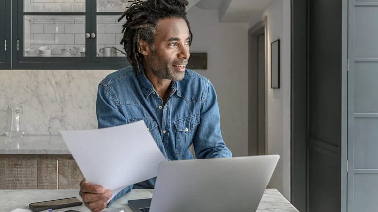 person at kitchen counter with laptop oDMjYzA.width .jpg