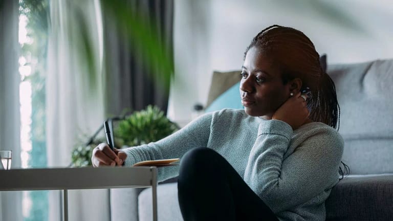 person writing in notebook at home wtymJ.width .jpg
