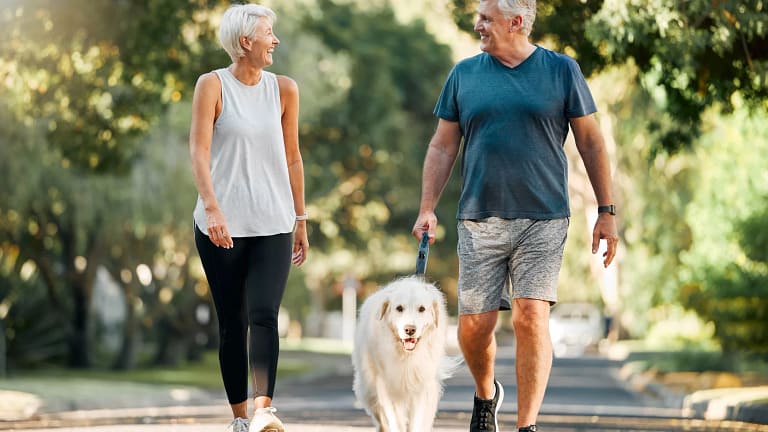 senior couple walking dog gettyimages .jpg