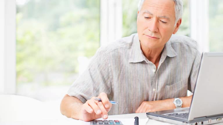 senior man using calculator gettyimages .jpg