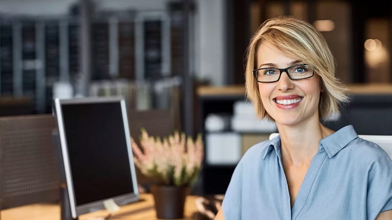 woman s smiling desk gettyimages .jpg